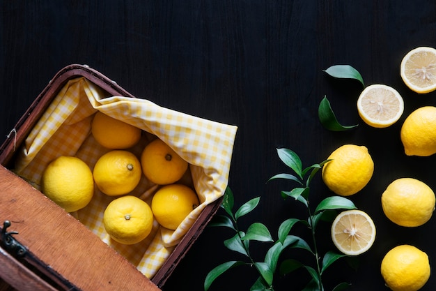 Fresh yellow lemons on black background