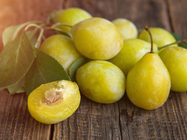 Fresh yellow plum closeup yellow plum in on a wooden table rustic background