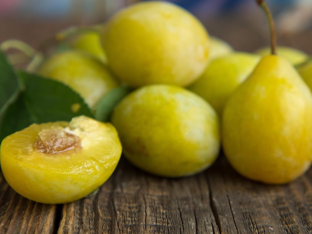 Fresh yellow plum closeup yellow plum in on a wooden table rustic background