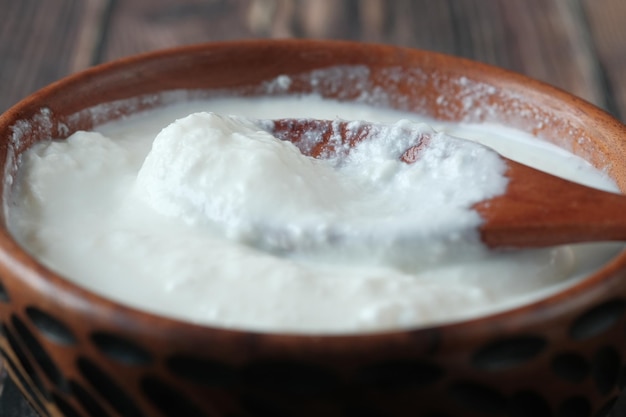 Fresh yogurt in a bowl on table