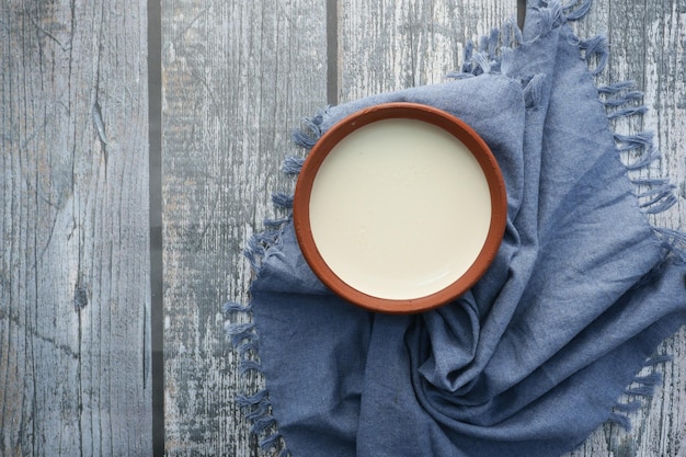 Fresh yogurt in a bowl on table