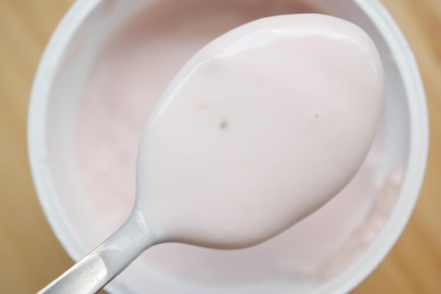 Fresh yogurt on a spoon close up