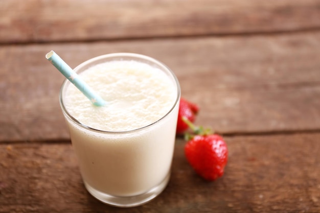 Fresh yogurt with strawberry on wooden background