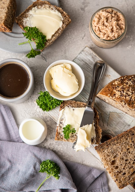 Freshly baked artisan multigrain bread with butter and pate