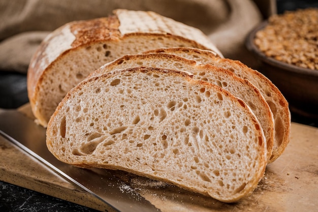 Freshly baked bread cut into chunks on a wooden Board