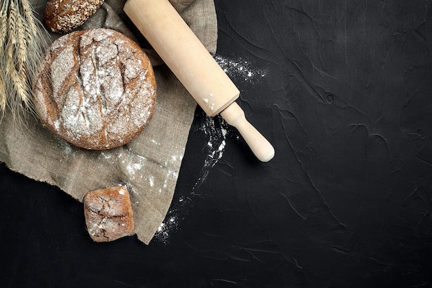 Freshly baked bread on dark kitchen table top view