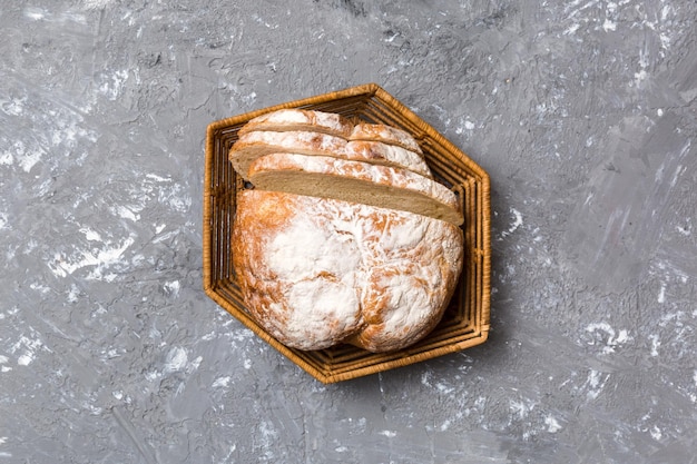 Freshly baked bread slices on basket against natural background top view Sliced bread