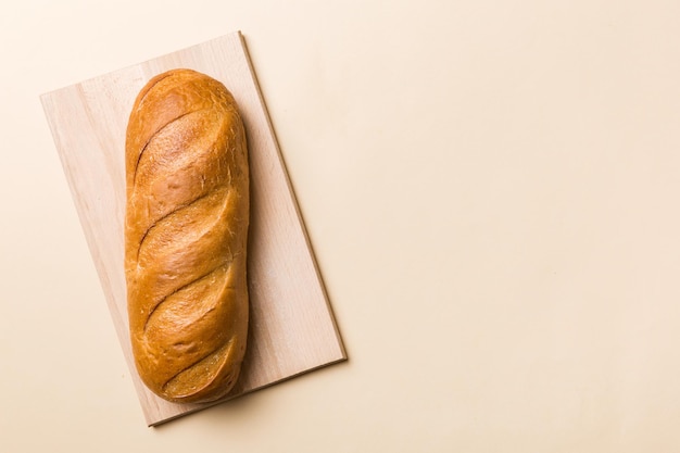 Freshly baked bread with napkin on rustic table top view Healthy white bread loaf isolated