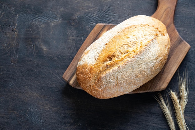 Freshly baked bread on wooden cutting board