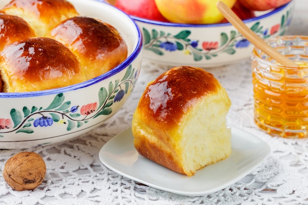 Freshly baked brioche buns with honey 