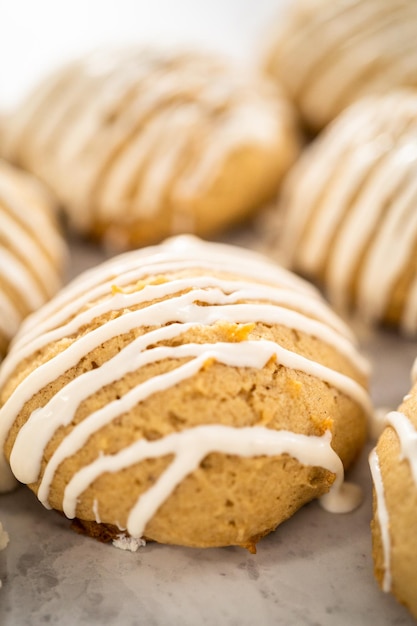 Freshly baked chocolate cookies with eggnog scones with a white chocolate drizzle on top.