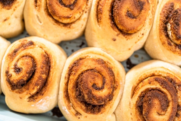 Freshly baked cinnamon rolls in a blue baking pan