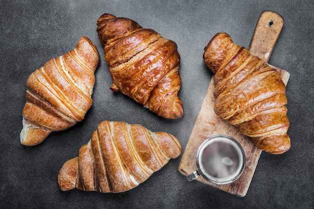 Freshly baked croissants and a Cup of coffee on the table. the view from the top