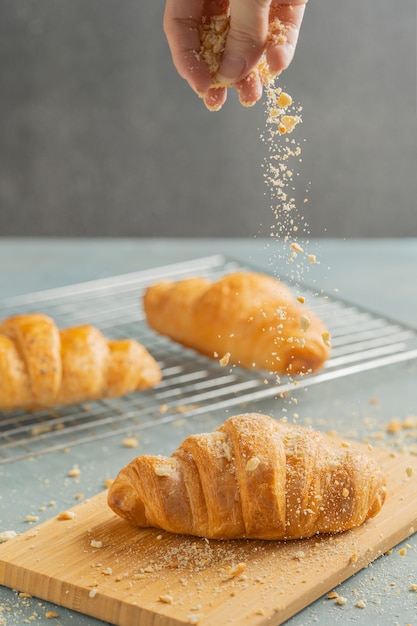 Freshly baked croissants on wooden plate. 