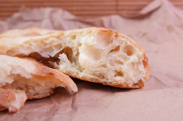 Freshly baked georgian pita bread on parchment paper. Delicious simple food. Close-up