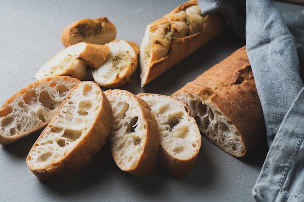 Freshly baked homemade bread with crispy crust on gray background