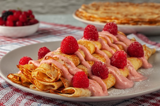 Freshly baked homemade pancakes with fresh raspberries and yoghurt