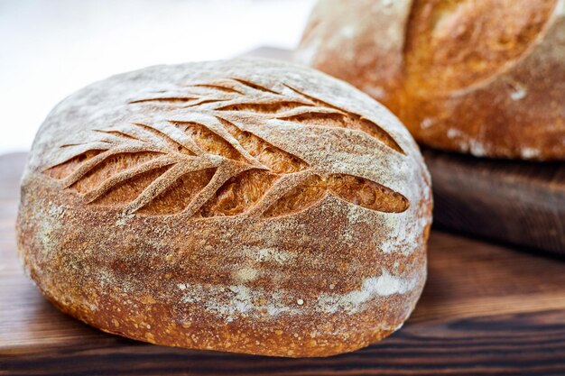 Freshly baked homemade wheat bread on a wooden background