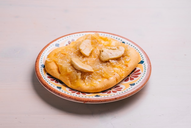 Freshly baked mini pizza with chicken and onions. Traditional Spanish pastry with vegetables.