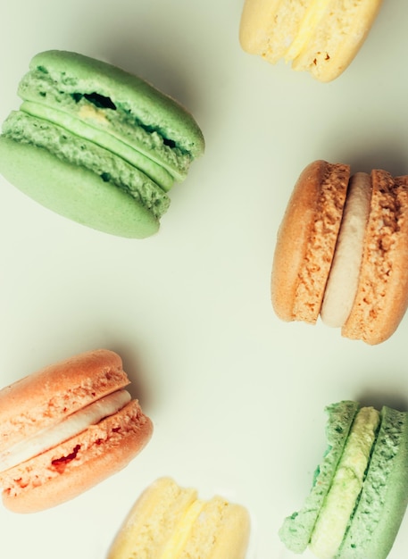 Freshly baked painted macarons on a white surface, isolate. French pastries