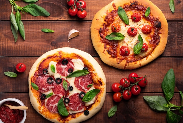 Freshly baked pizza with tomatoes and basil on a wooden board