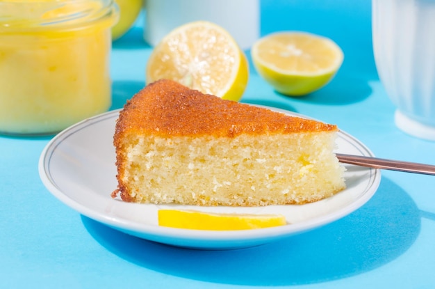 Freshly baked sponge cake on plate lemon kurd and lemons