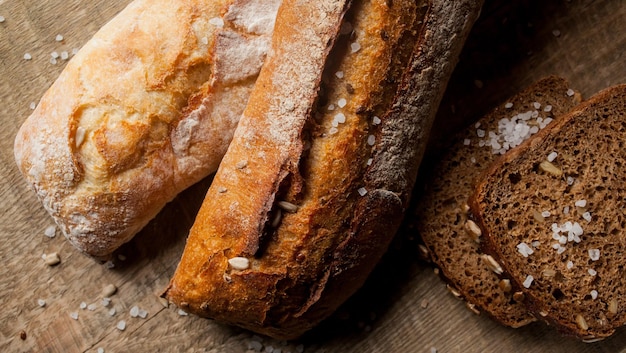 Freshly baked traditional bread with sunflower seeds on wooden table fresh baguette with salt