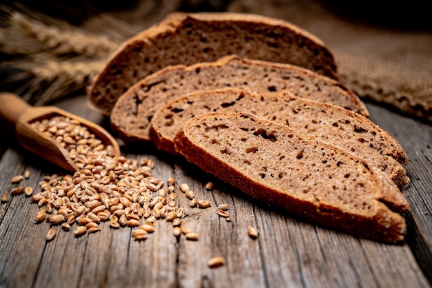 Freshly baked traditional bread on wooden table. Healthy food