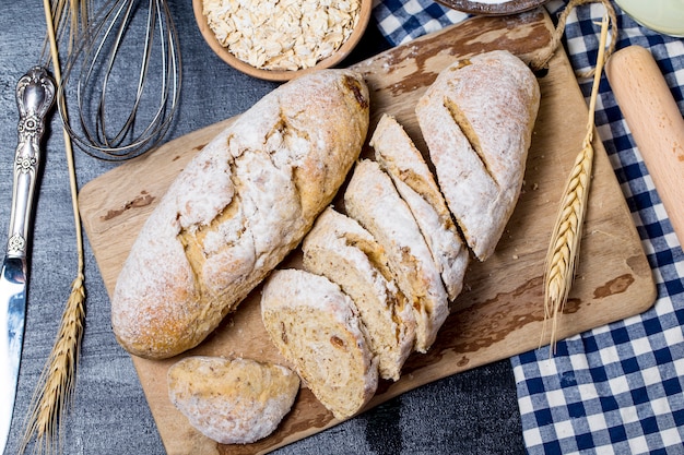 Freshly baked traditional bread on wooden table Oatmeal Bread