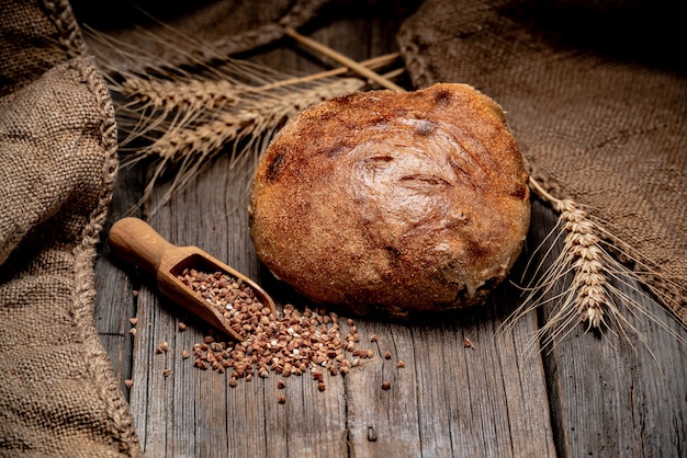 Freshly baked traditional bread on wooden table