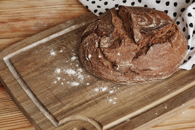 Freshly baked traditional rye bread on wooden table