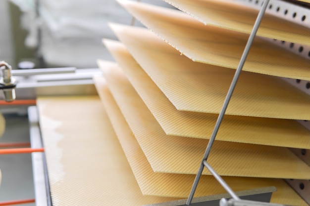 Freshly baked wafer sheets move along the conveyor of a confectionery factory