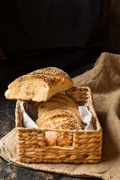 Freshly baked wheat bread on natural linen napkin and bag. Homemade bakery. Slice of bread