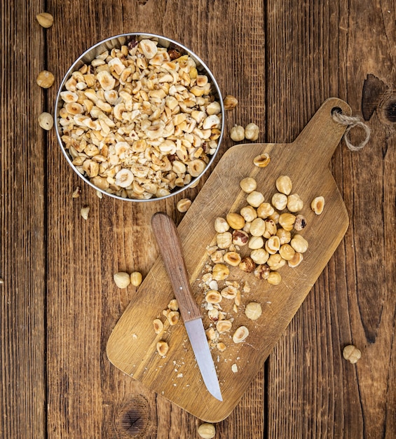 Freshly chopped Hazelnuts on an old wooden table close up selective focus