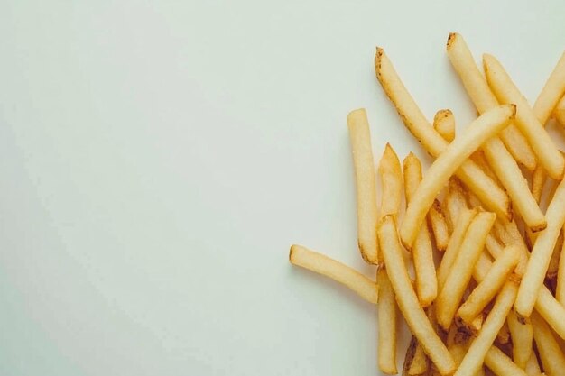 Photo freshly cooked golden fries on a plain white setting