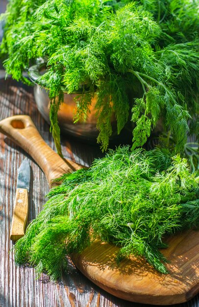 Freshly cut green young dill on a kitchen board