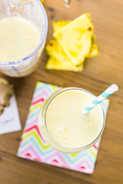 Freshly made pineapple ginger smoothie with Greek yogurt and juice.