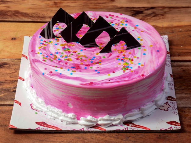 Freshly made white forest cream cake on wooden table selective focus