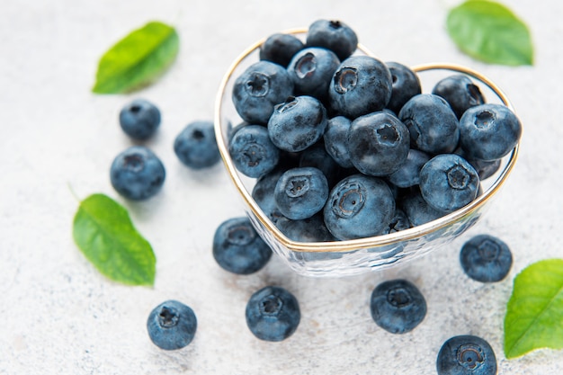 Freshly picked blueberries on a concrete background. Concept for healthy eating