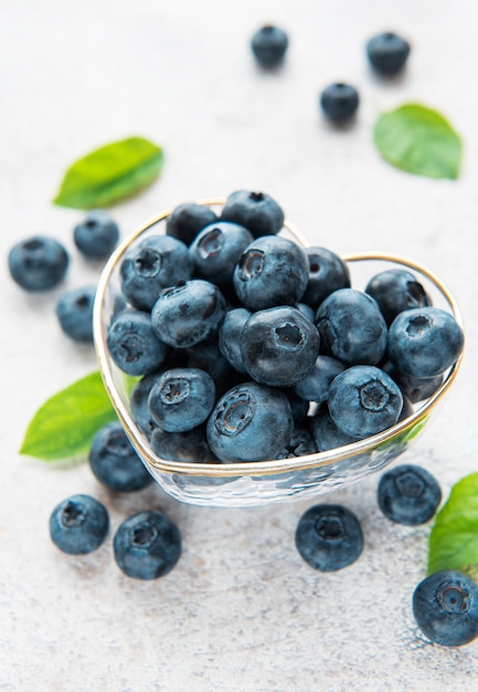 Freshly picked blueberries on a concrete background. Concept for healthy eating