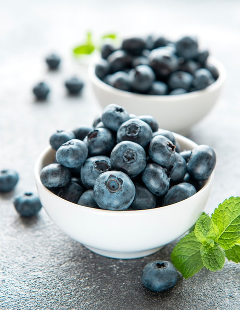 Freshly picked blueberries on a concrete background. Concept for healthy eating