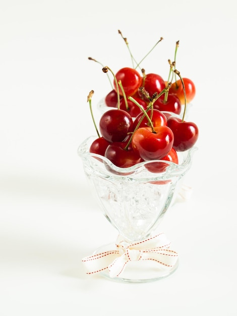 Freshly picked heap of cherries in glass dishes.