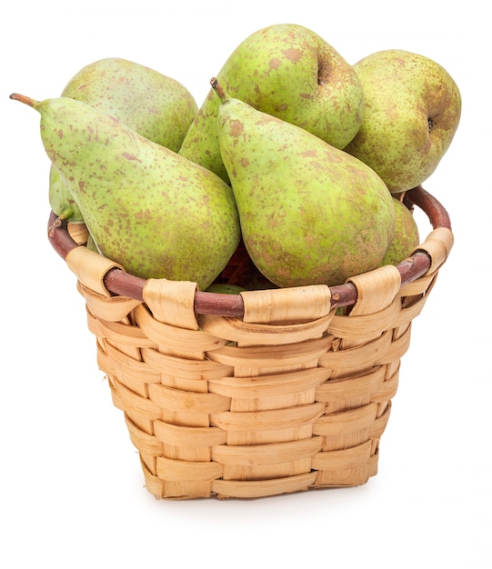 Freshly picked raw green pears from the tree in wicker basket.