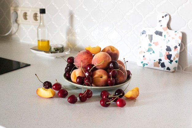 Freshly red peaches on white backgroundRipe cherries on white background