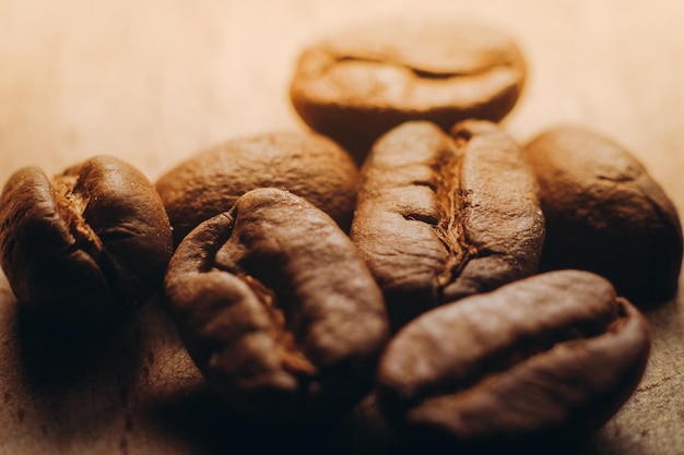 Freshly roasted coffee beans lie on a wooden table Closeup of coffee beans