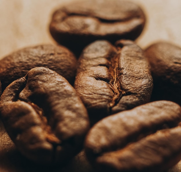 Freshly roasted coffee beans lie on a wooden table