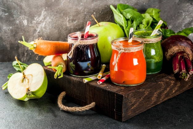 Freshly squeezed juices and smoothies from vegetables On dark stone