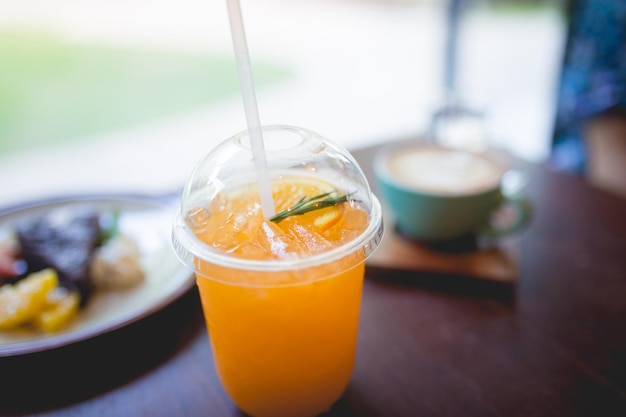 Freshly squeezed orange juice with drinking straw in breakfast time