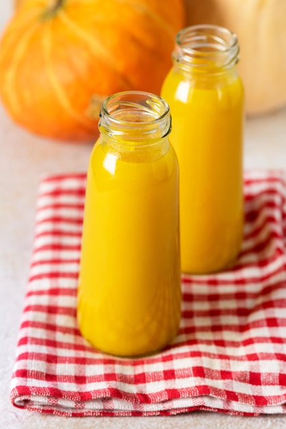 Freshly Squeezed Pumpkin Juice in Bottle Bottle with Juice on Napkin Vegetarian Breakfast