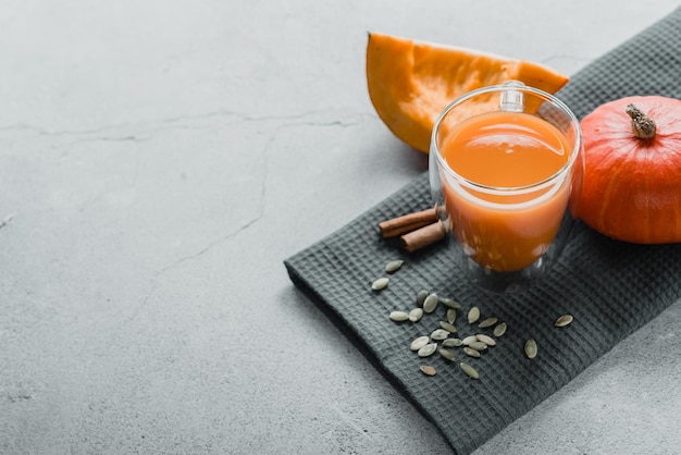 Freshly squeezed pumpkin juice with parsley and pumpkin seeds top view